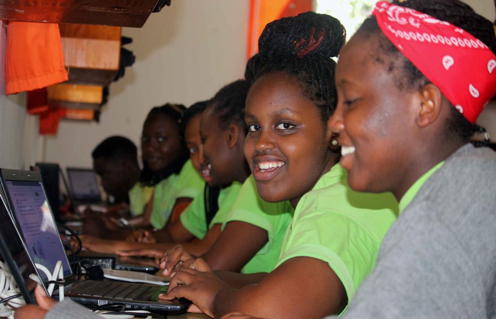 Smiling students using computer