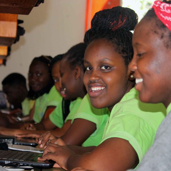 Smiling students using computer